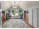Cozy bedroom with sloped ceiling, large window, comfortable chair, and built-in shelving at 13183 N 95Th St, Longmont, CO 80504