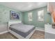 Inviting bedroom features soothing green walls and a comfortable bed bathed in natural light at 13183 N 95Th St, Longmont, CO 80504