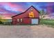 Charming red barn featuring an open loft doorway against a vibrant sunset sky at 13183 N 95Th St, Longmont, CO 80504