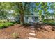 Quaint home featuring a lush front yard with mature trees and a cozy porch at 13183 N 95Th St, Longmont, CO 80504