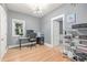 Bright home office featuring hardwood floors, gray walls, and a window providing natural light at 13183 N 95Th St, Longmont, CO 80504