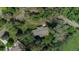 Aerial view of a home nestled among lush trees, highlighting the property's privacy and verdant surroundings at 1705 Stonehenge Dr, Lafayette, CO 80026