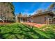 Well-maintained home exterior features a spacious backyard with a wooden deck and lush lawn at 1705 Stonehenge Dr, Lafayette, CO 80026