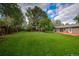 Expansive backyard with lush green lawn and mature trees at 1705 Stonehenge Dr, Lafayette, CO 80026