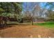 Secluded backyard showcasing a deck, lawn, and mature trees at 1705 Stonehenge Dr, Lafayette, CO 80026