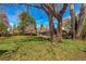 Expansive backyard featuring mature trees and a well-maintained lawn, offering ample outdoor space at 1705 Stonehenge Dr, Lafayette, CO 80026