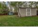Backyard featuring two storage sheds and green lawn at 1705 Stonehenge Dr, Lafayette, CO 80026