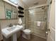 Bathroom showcasing a glass-enclosed shower, toilet, and a sink with mirror at 1705 Stonehenge Dr, Lafayette, CO 80026