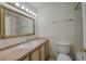 Well-lit bathroom with marble countertop, framed mirror, and neutral decor at 1705 Stonehenge Dr, Lafayette, CO 80026