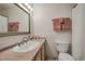 Well-maintained bathroom featuring a vanity with mirror, sink, toilet, and decorative accents at 1705 Stonehenge Dr, Lafayette, CO 80026