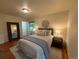 Bright bedroom features a comfortable bed, wood floors, and a stylish mirror at 1705 Stonehenge Dr, Lafayette, CO 80026