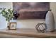 Close-up of vases, picture frames and abstract shapes on top of a wooden dresser at 1705 Stonehenge Dr, Lafayette, CO 80026