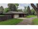 A charming single-story brick house with attached garage and lovely landscaping creates a welcoming curb appeal at 1705 Stonehenge Dr, Lafayette, CO 80026