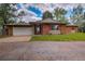 Charming brick single-story home with a two-car garage, red shutters and well-maintained front lawn at 1705 Stonehenge Dr, Lafayette, CO 80026