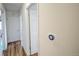 Hallway with hardwood floors, access to rooms, and smart thermostat at 1705 Stonehenge Dr, Lafayette, CO 80026