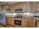 Kitchen featuring stainless appliances, granite counters and wood cabinets at 1705 Stonehenge Dr, Lafayette, CO 80026