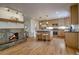 Bright kitchen featuring granite counters, stainless appliances, an island with seating, and a beautiful fireplace at 1705 Stonehenge Dr, Lafayette, CO 80026