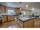 Well-lit kitchen with an island, granite countertops, stainless steel appliances, and seamless flow to dining area at 1705 Stonehenge Dr, Lafayette, CO 80026