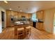 Modern kitchen with stainless steel appliances, an island with seating, and wooden cabinets at 1705 Stonehenge Dr, Lafayette, CO 80026