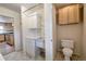 Convenient laundry room with sink, white cabinets and adjacent toilet room at 1705 Stonehenge Dr, Lafayette, CO 80026
