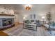 Warm living room showcasing a stone fireplace, comfortable seating, and stylish decor at 1705 Stonehenge Dr, Lafayette, CO 80026