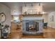 Open-concept living space with a stone fireplace seamlessly connected to the kitchen area at 1705 Stonehenge Dr, Lafayette, CO 80026