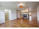 Open floor plan with hardwood floors, fireplace, and a view into the kitchen at 1705 Stonehenge Dr, Lafayette, CO 80026