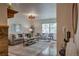 Comfortable living room with a gray sofa, accent chairs, and view into the home's entryway at 1705 Stonehenge Dr, Lafayette, CO 80026