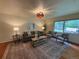 Bright living room featuring a comfortable sofa, accent chairs, rug, and large window at 1705 Stonehenge Dr, Lafayette, CO 80026