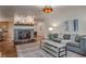 Inviting living room with a stone fireplace, gray sofa, and coffee table, featuring hardwood floors at 1705 Stonehenge Dr, Lafayette, CO 80026