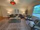 Inviting living room with a stylish grey sofa, decorative rug, and ample natural light at 1705 Stonehenge Dr, Lafayette, CO 80026
