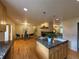 Open concept space showing kitchen island, adjacent fireplace, and dining area at 1705 Stonehenge Dr, Lafayette, CO 80026