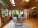 Bright sunroom with wood paneling, skylight, and views of lush greenery at 1705 Stonehenge Dr, Lafayette, CO 80026
