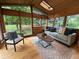 Sunroom featuring wood paneling, skylight, and lots of windows overlooking a treed area at 1705 Stonehenge Dr, Lafayette, CO 80026