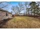 A cozy tan house backyard with a well-maintained lawn and tall trees at 11623 W Hornsilver Mtn, Littleton, CO 80127