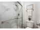 Modern bathroom featuring a glass-enclosed shower with sleek, marble-look tile surround at 11623 W Hornsilver Mtn, Littleton, CO 80127