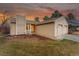 View of the front of the property with a two-car garage and a well-maintained lawn, under a colorful dusk sky at 11623 W Hornsilver Mtn, Littleton, CO 80127