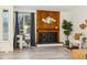 Close up of the living room with a modern fireplace, wood paneling, and contemporary decor with natural light at 11623 W Hornsilver Mtn, Littleton, CO 80127