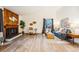Bright living room featuring wood floors, a wood-paneled fireplace and contemporary decor with natural light at 11623 W Hornsilver Mtn, Littleton, CO 80127
