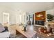 Bright living room boasts wood floors, fireplace with wood paneling, and contemporary decor at 11623 W Hornsilver Mtn, Littleton, CO 80127