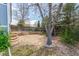Spacious backyard featuring a mature tree, wooden fence, and tiered landscaping, offering a peaceful outdoor space at 4022 S Kalispell St, Aurora, CO 80013