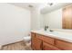 Powder room with a wood vanity, sink, and nearby toilet at 4022 S Kalispell St, Aurora, CO 80013