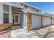A charming home featuring a brick-accented garage and inviting front entrance with steps and a security door at 4022 S Kalispell St, Aurora, CO 80013