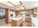 Kitchen features light wood cabinets, a central island, and modern appliances at 4022 S Kalispell St, Aurora, CO 80013