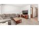 Neutral living room with comfortable seating and entertainment center at 4022 S Kalispell St, Aurora, CO 80013