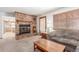 Cozy living area with a brick fireplace and adjacent kitchen at 4022 S Kalispell St, Aurora, CO 80013