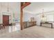 Open-concept living area with a staircase, tiled entry, and chandelier lighting at 4022 S Kalispell St, Aurora, CO 80013