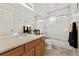 Clean bathroom, featuring a tub and shower combo, double vanity, and wood cabinets at 1894 S Marshall Cir, Lakewood, CO 80232