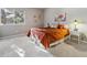 Spacious bedroom with orange bedding and window at 1894 S Marshall Cir, Lakewood, CO 80232