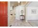 Bright entryway with tile floor, console table, and view to living room at 1894 S Marshall Cir, Lakewood, CO 80232